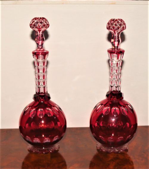 A Pair of Cranberry Cut Glass Decanters.