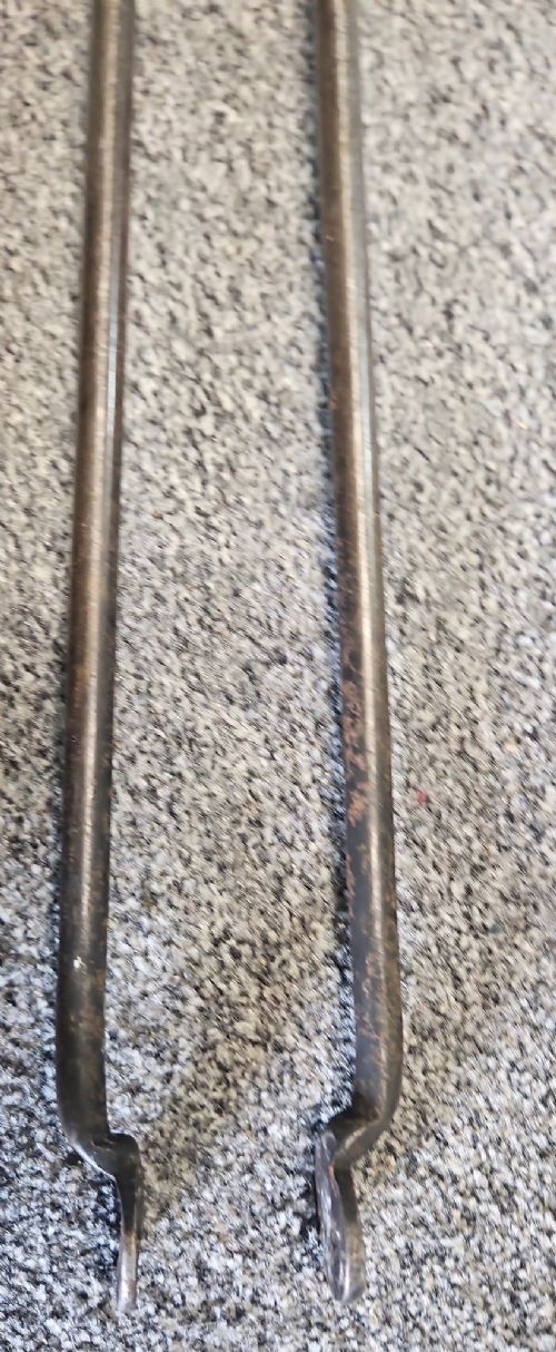 A three-piece set of Georgian polished steel fire tools comprising a poker, a pierced shovel, and a pair of tongs with faceted finials. View III
