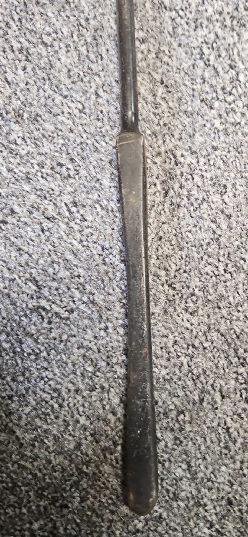 A three-piece set of Georgian polished steel fire tools comprising a poker, a pierced shovel, and a pair of tongs with faceted finials. View IV