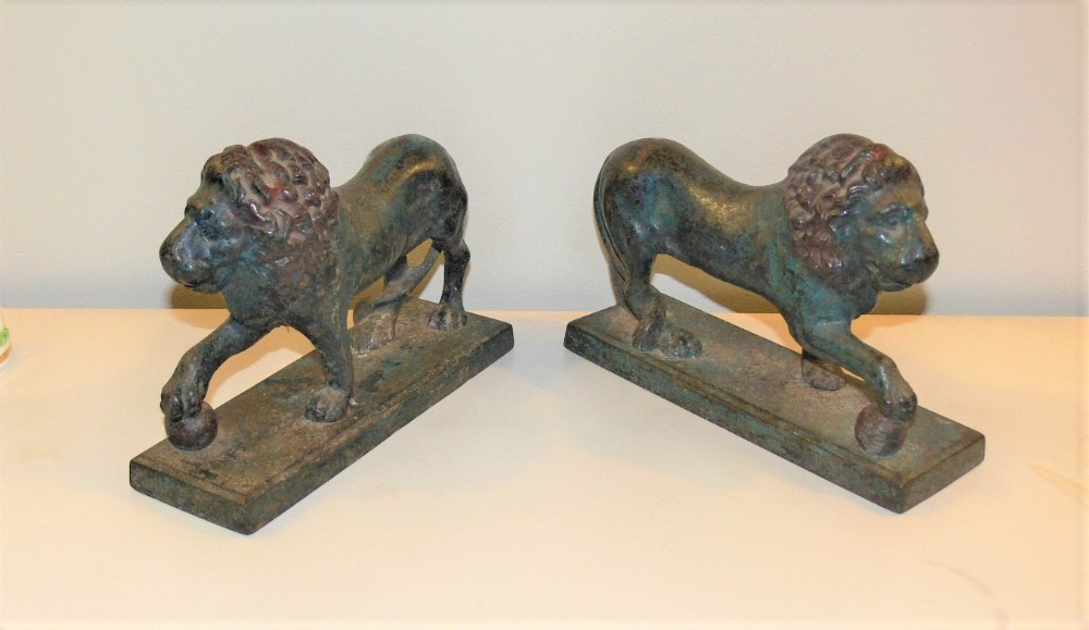 A pair of cold painted cast iron lions.