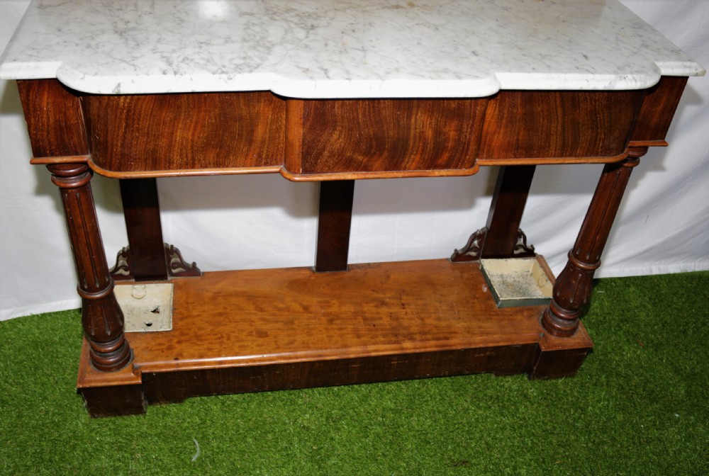 A Victorian mahogany hall stand featuring turned pegs, fretwork carving, an integrated barometer and thermometer, a white marble console surface, and lower drip trays. View IV