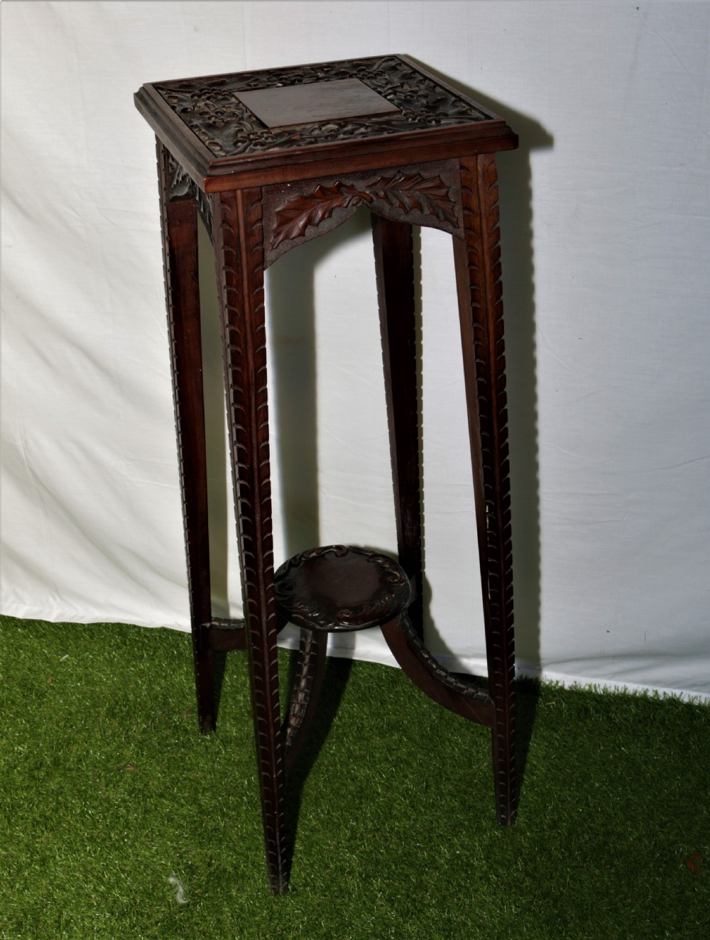 Carved oak plant stand