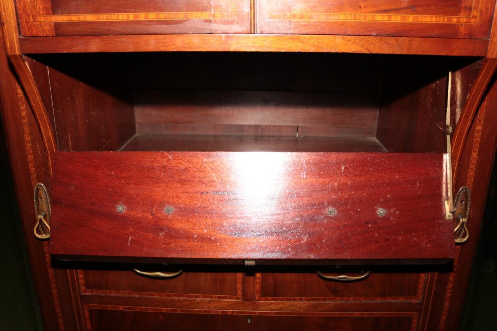 A large Edwardian inlaid mahogany combination wardrobe featuring twin mirror doors flanking a central section of drawers and a upper cupboard. View IV