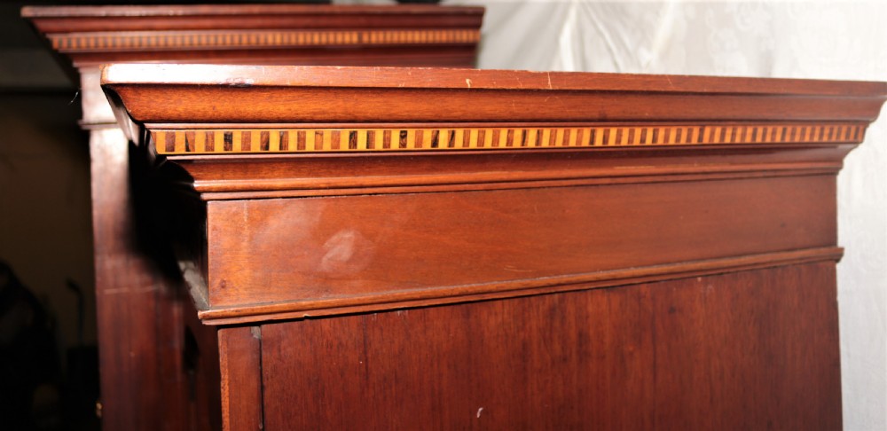 A large Edwardian inlaid mahogany combination wardrobe featuring twin mirror doors flanking a central section of drawers and a upper cupboard. View VII