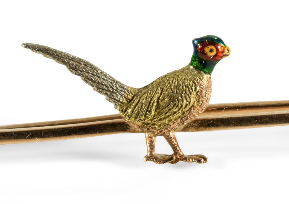 A Pheasant gold bar broach.