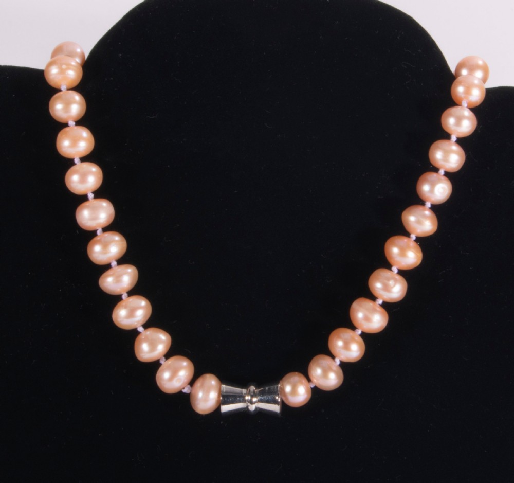 A String of dyed pink pearls.
