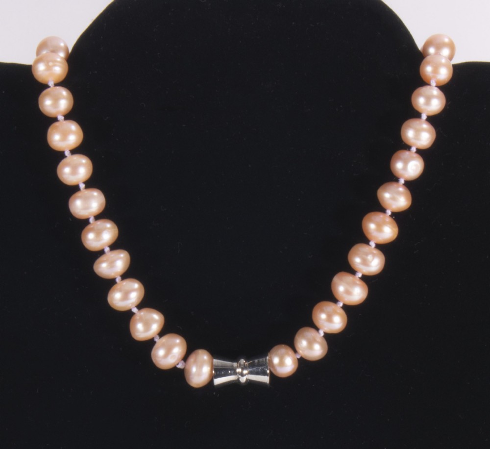 A String of dyed pink pearls. View II