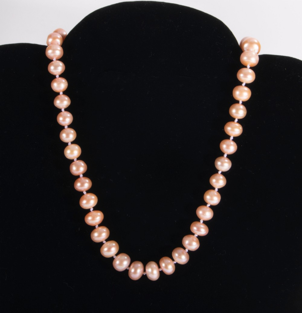 A String of dyed pink pearls. View IV