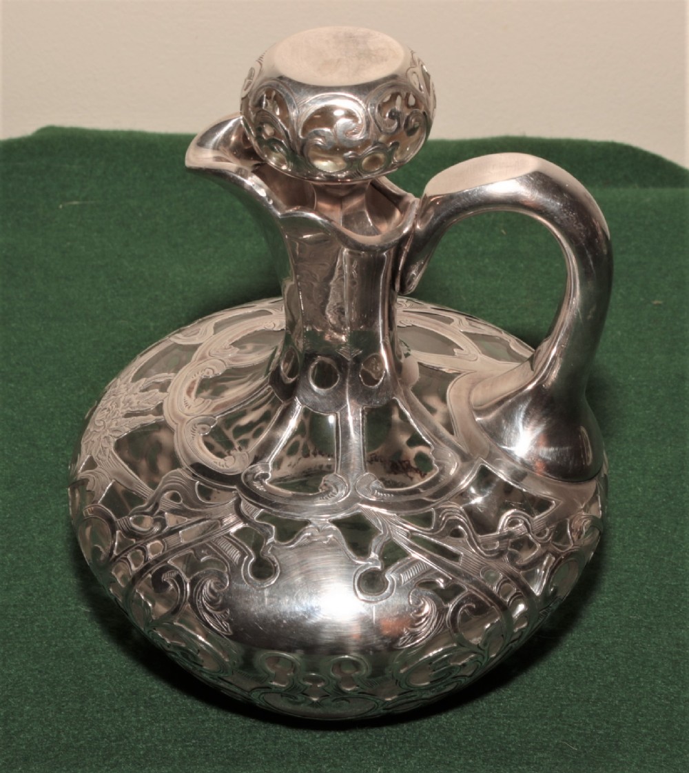  A glass and silver plated claret jug.