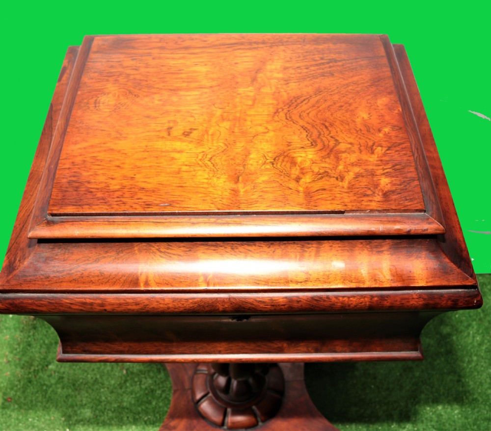An open antique rosewood tea poy displaying internal wooden canisters, circular velvet-lined bowl apertures, a fluted pedestal stem, and a quadform base. View V
