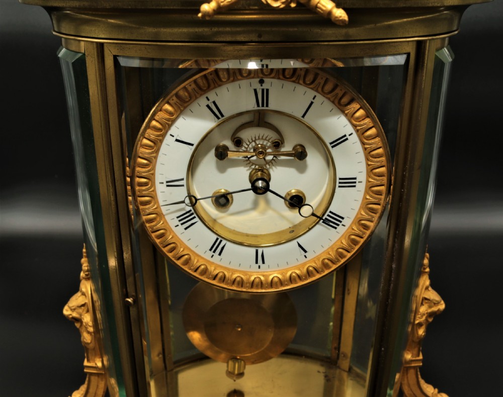 A French Louis XVI style gilt bronze four-glass mantel clock crowned with a decorated classical urn finial and a white enamelled dial. View XIV