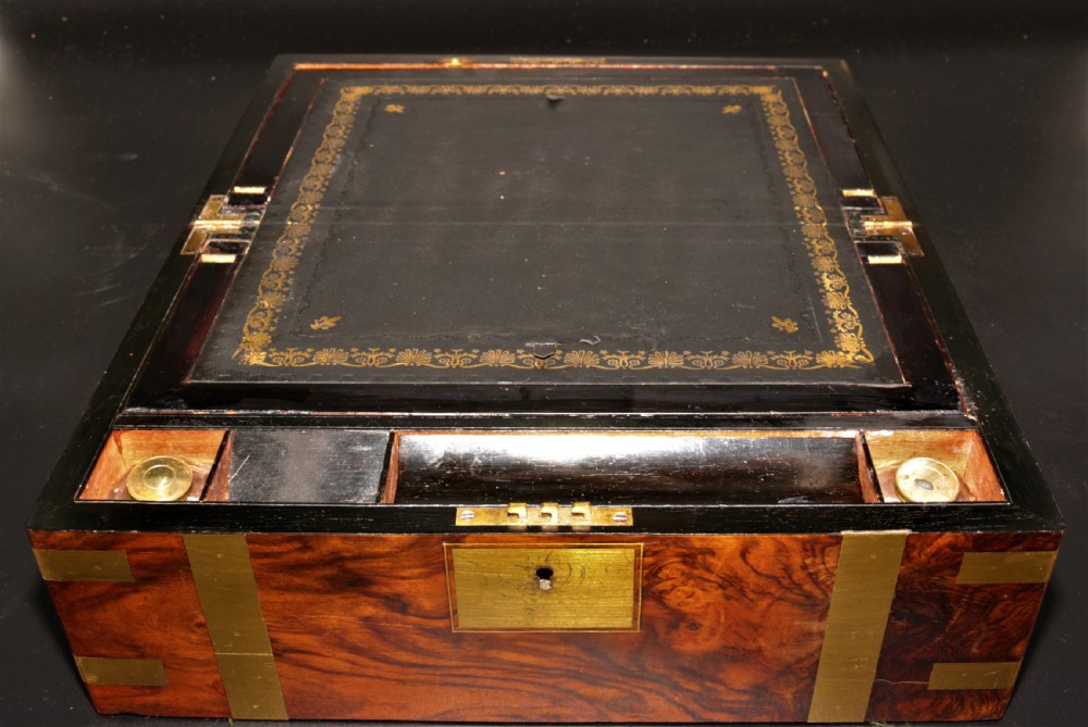 A rectangular Victorian burr walnut writing box featuring brass straps, corner mounts, an engraved central cartouche, and an escutcheon keyhole. View VIII