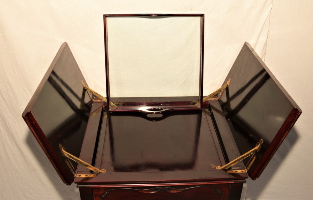 A dark mahogany metamorphic drinks table with cabriole legs, open side leaves, and an elevated glass tray displaying crystal glassware. View V