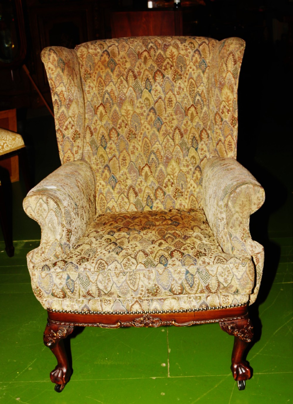 An Edwardian wingback armchair.
