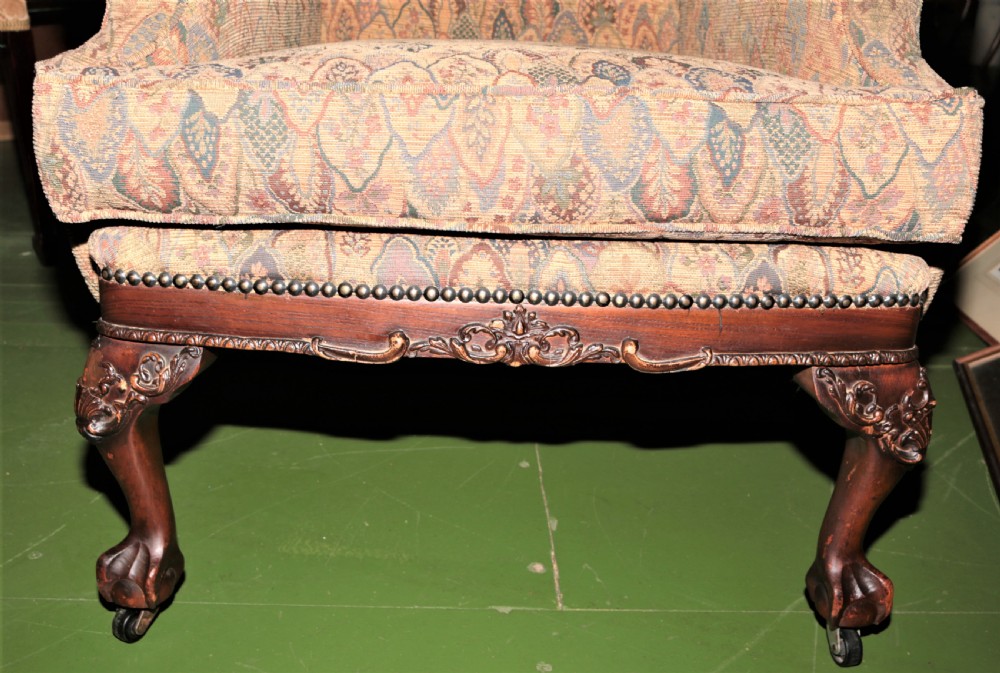 An Edwardian wingback armchair. View II