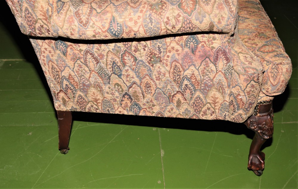 An Edwardian wingback armchair. View III