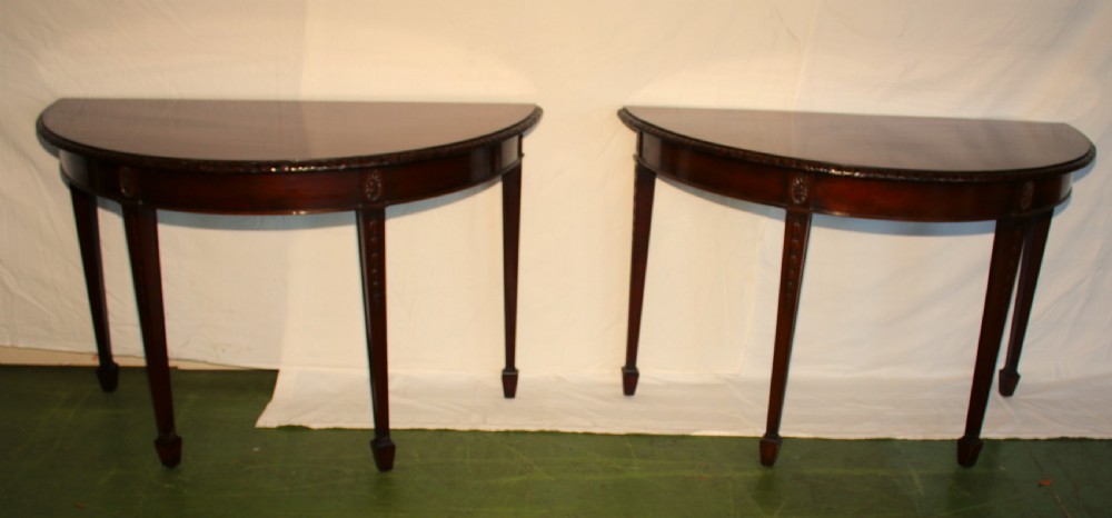An antique dark mahogany extending dining table featuring removable leaves, D-shaped end sections, and tapered square legs with carved detailing. View VII