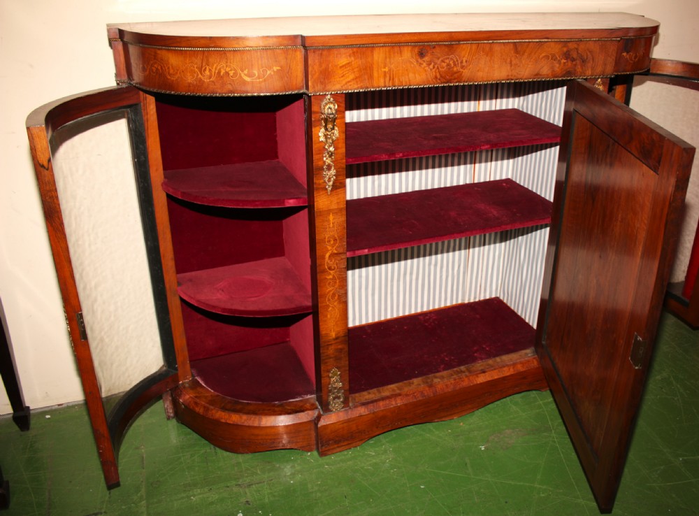 A Victorian walnut credenza featuring central marquetry inlay, curved glazed side display doors, and gilt bronze mounts. View III