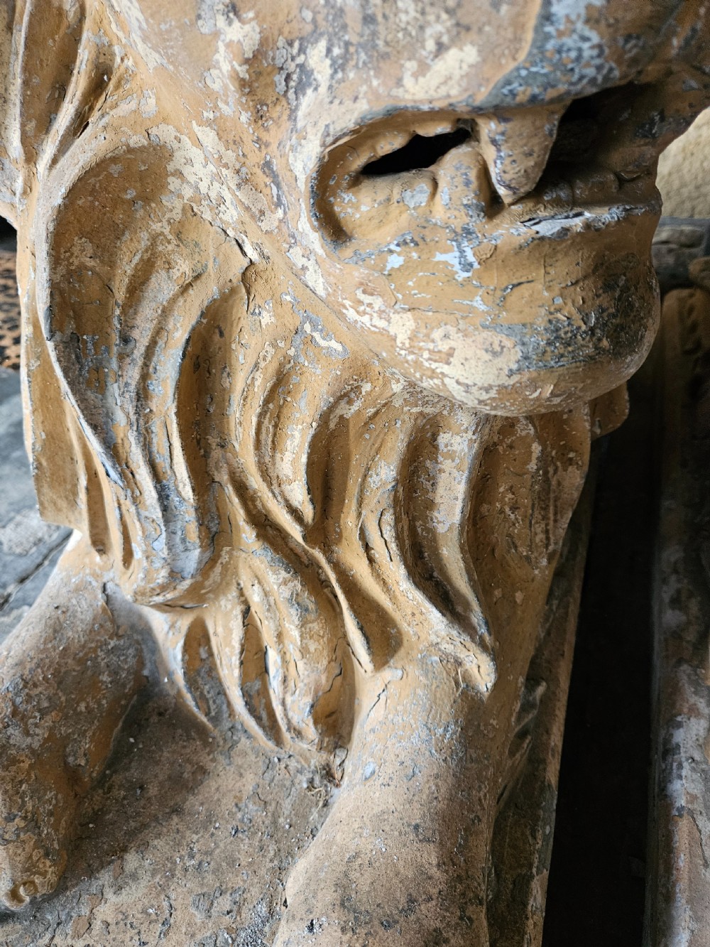 A pair of sculpted buff stone recumbent lion statues with detailed manes resting on integrated rectangular bases. View VIII
