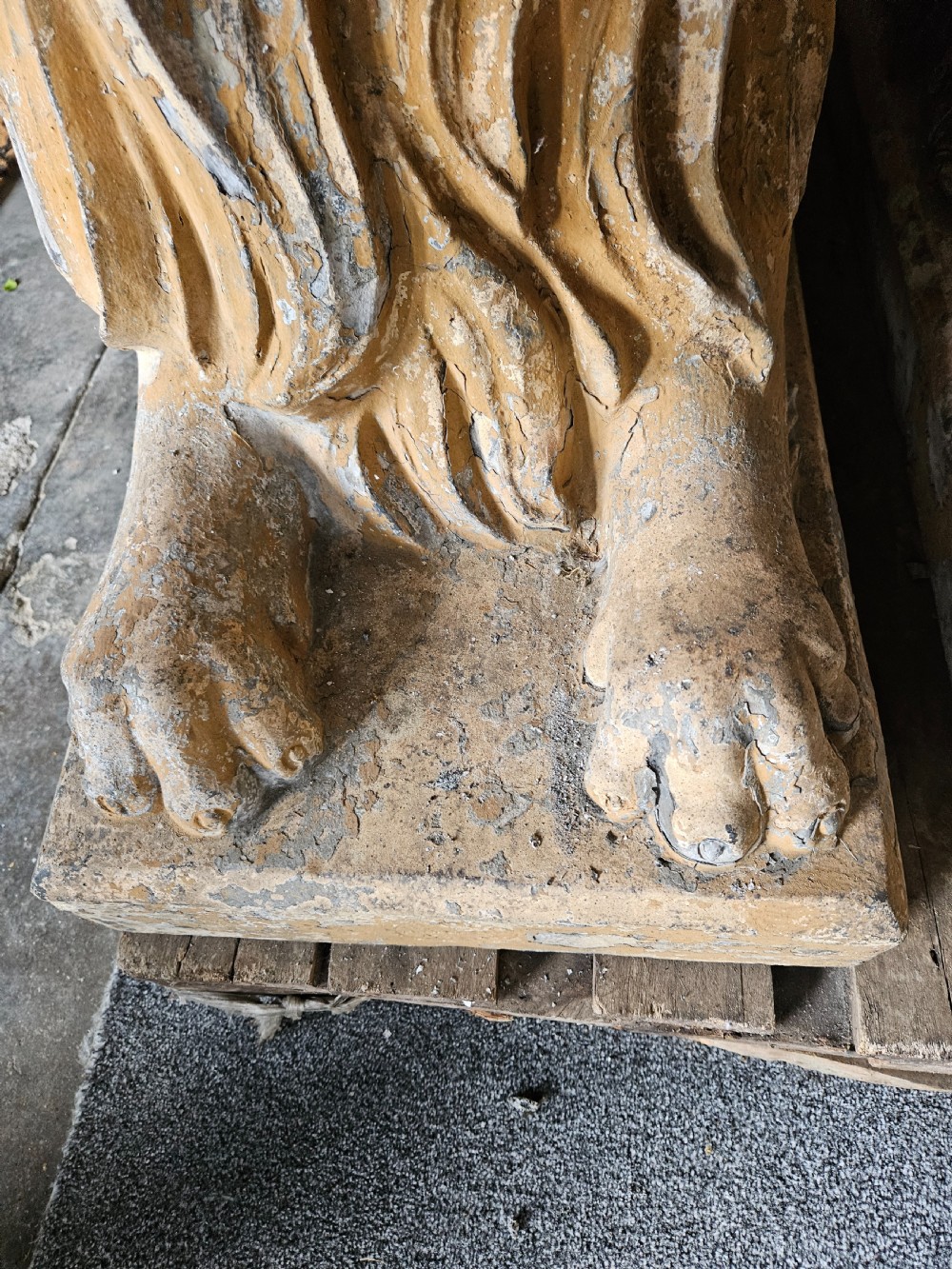 A pair of sculpted buff stone recumbent lion statues with detailed manes resting on integrated rectangular bases. View X