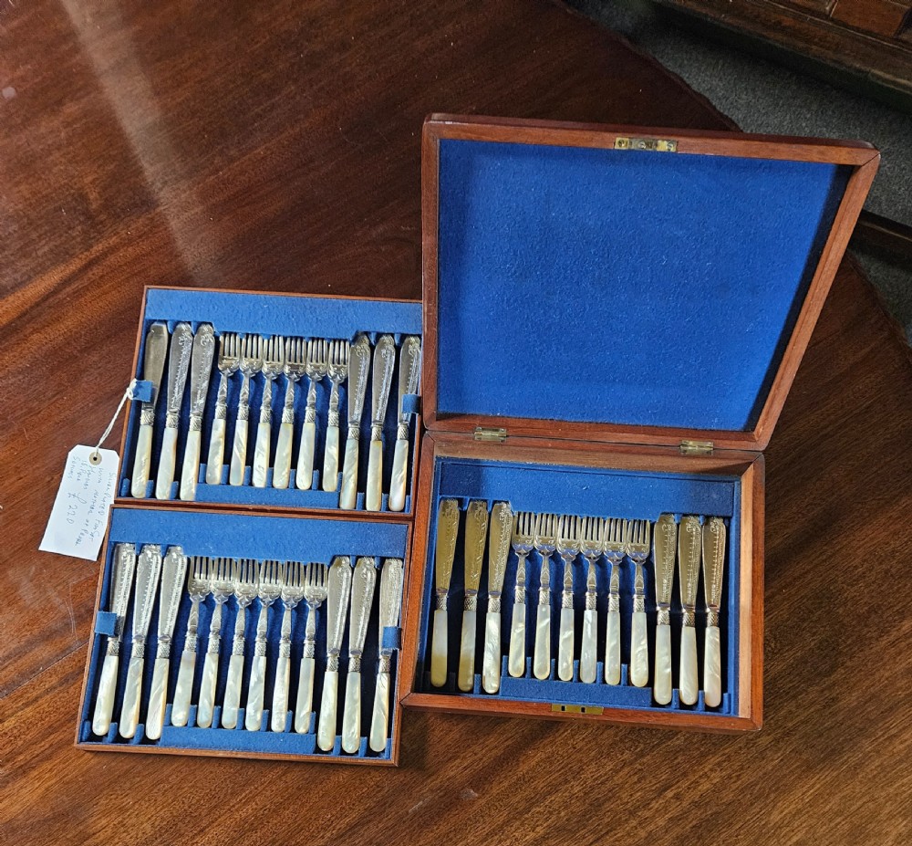 A thirty-six piece silver-plated fish cutlery set with mother-of-pearl handles presented inside a blue felt-lined wooden fitted canteen.