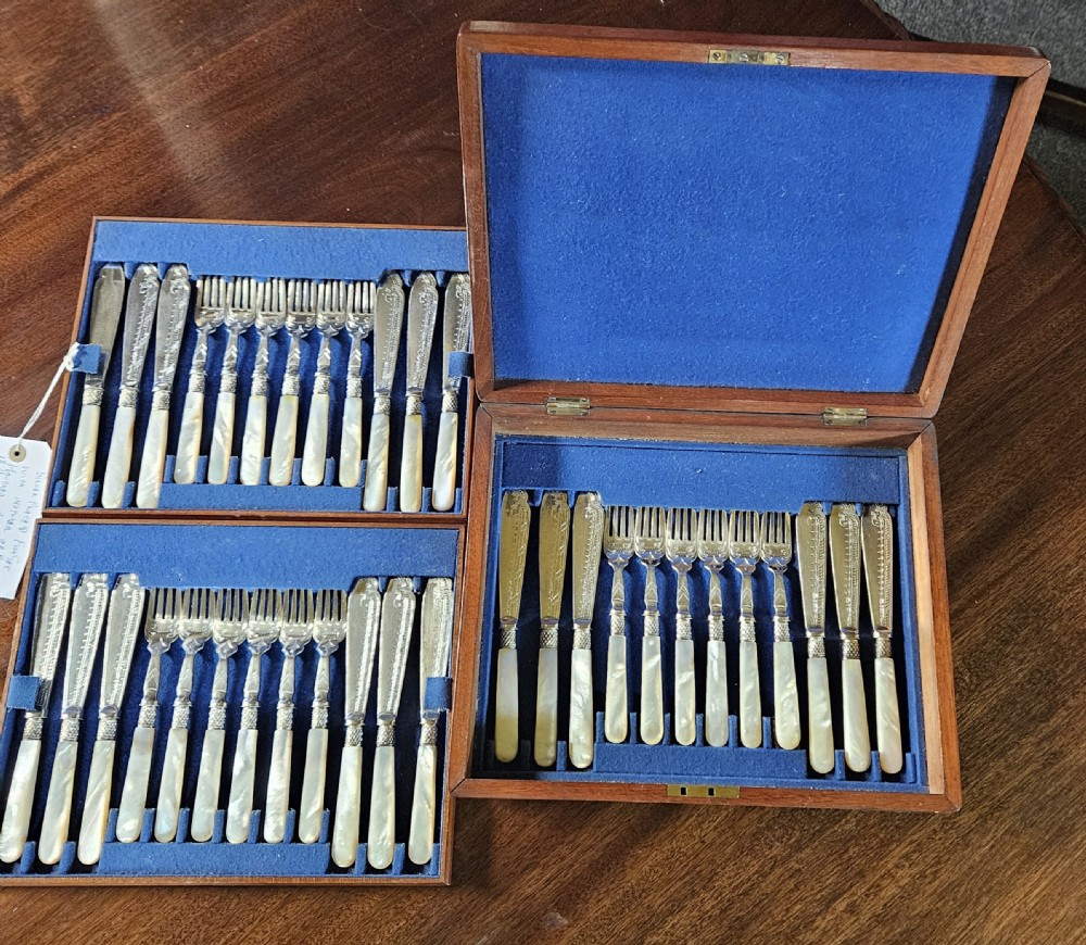 A thirty-six piece silver-plated fish cutlery set with mother-of-pearl handles presented inside a blue felt-lined wooden fitted canteen. View II