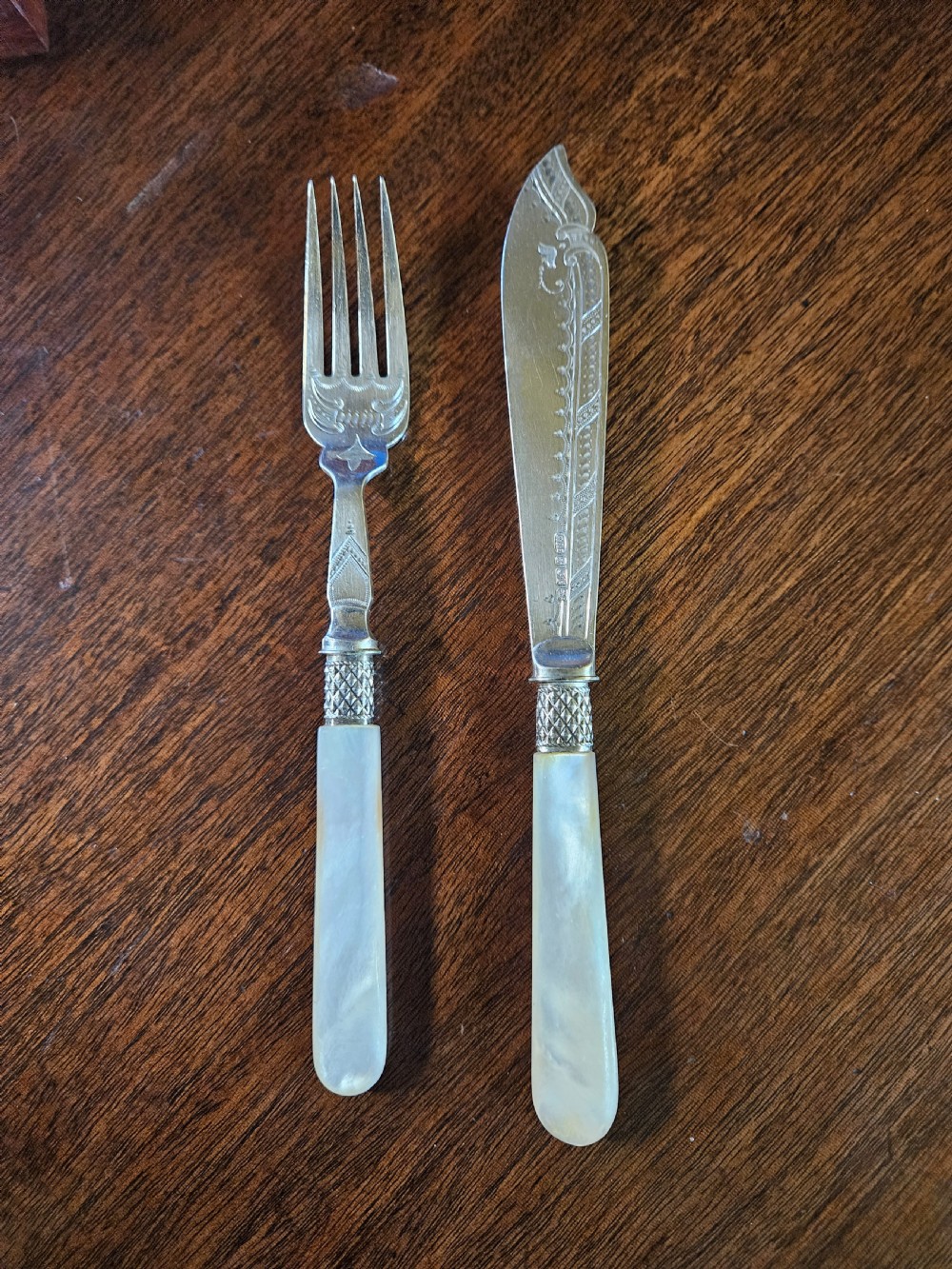 A thirty-six piece silver-plated fish cutlery set with mother-of-pearl handles presented inside a blue felt-lined wooden fitted canteen. View V