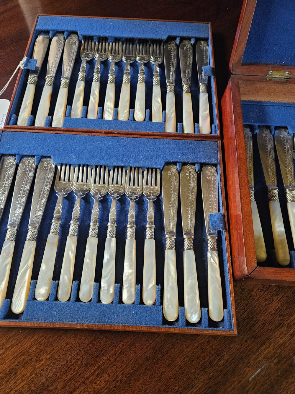 A thirty-six piece silver-plated fish cutlery set with mother-of-pearl handles presented inside a blue felt-lined wooden fitted canteen. View VI
