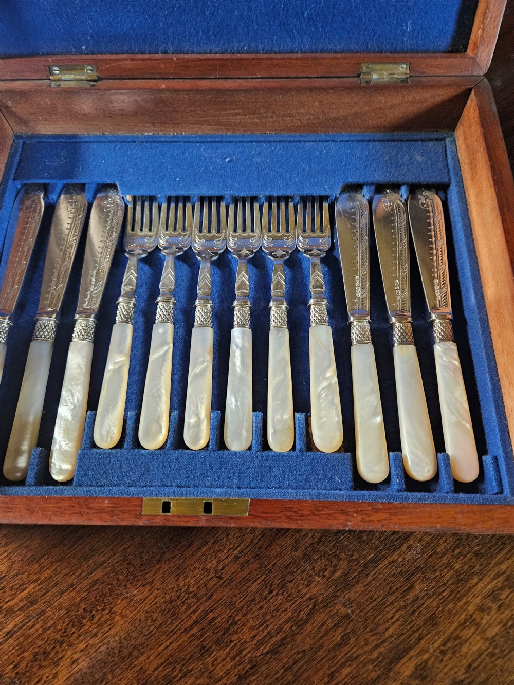 A thirty-six piece silver-plated fish cutlery set with mother-of-pearl handles presented inside a blue felt-lined wooden fitted canteen. View VII