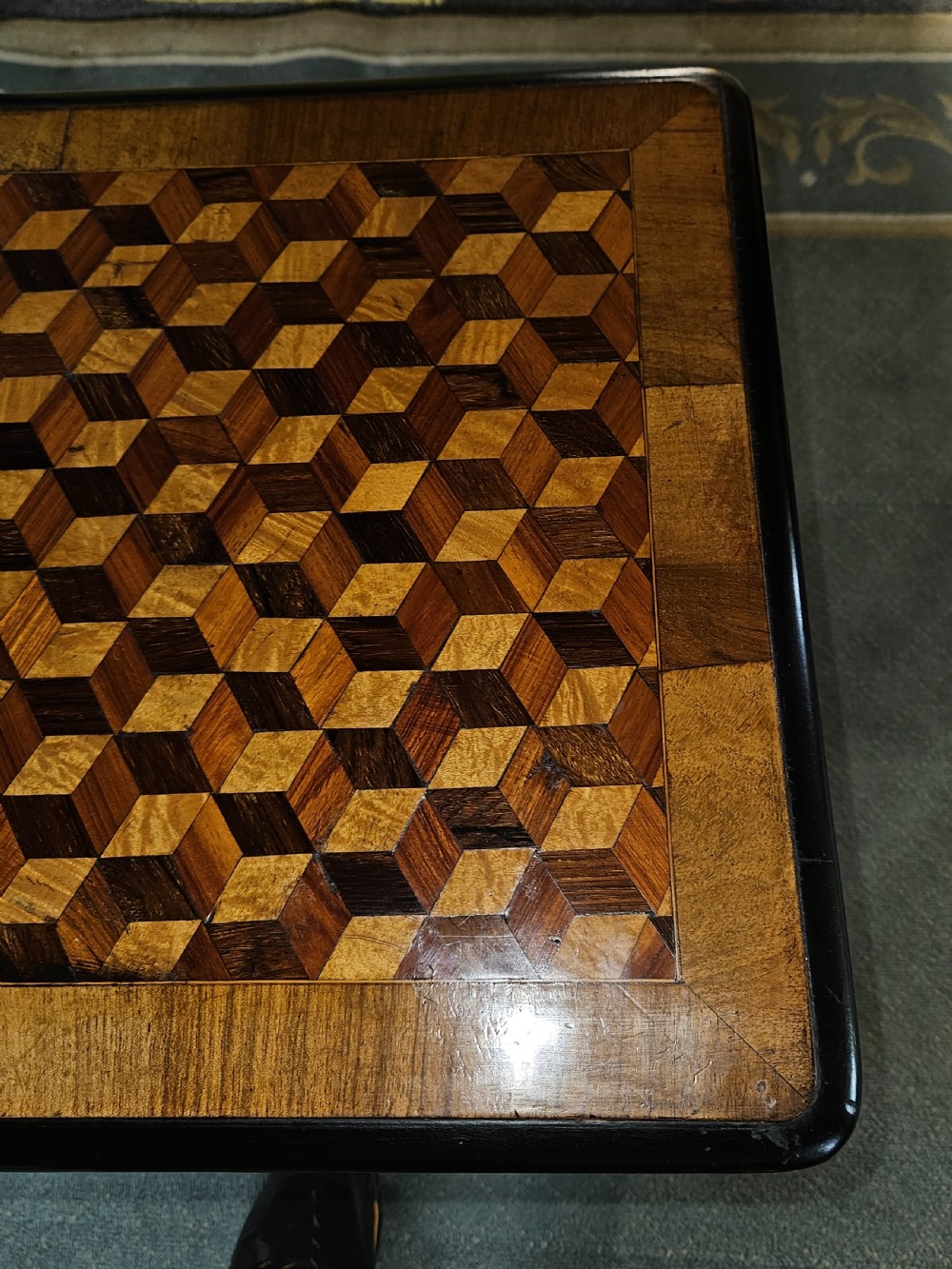 A rectangular wooden side table with a geometric tumbling block parquetry top and barley twist turned legs. View V