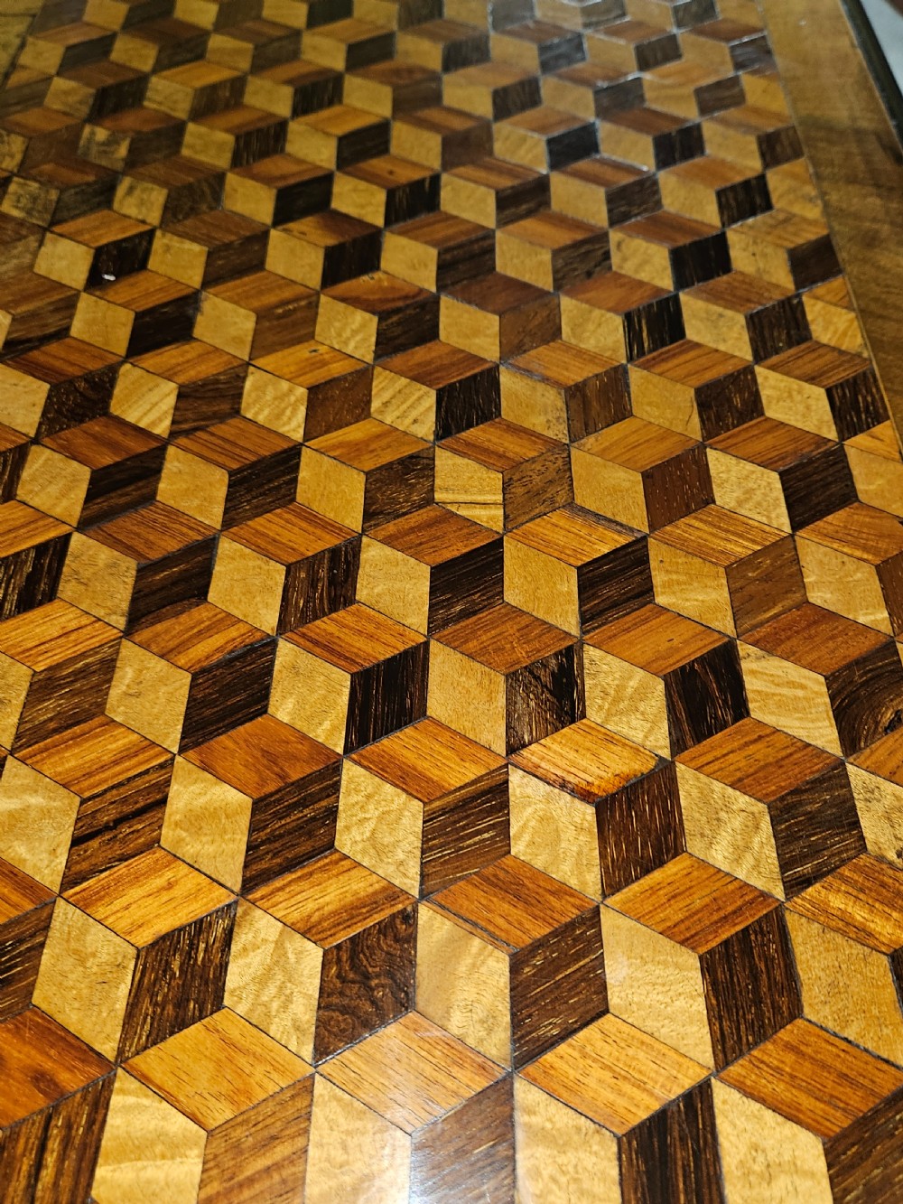 A rectangular wooden side table with a geometric tumbling block parquetry top and barley twist turned legs. View VI