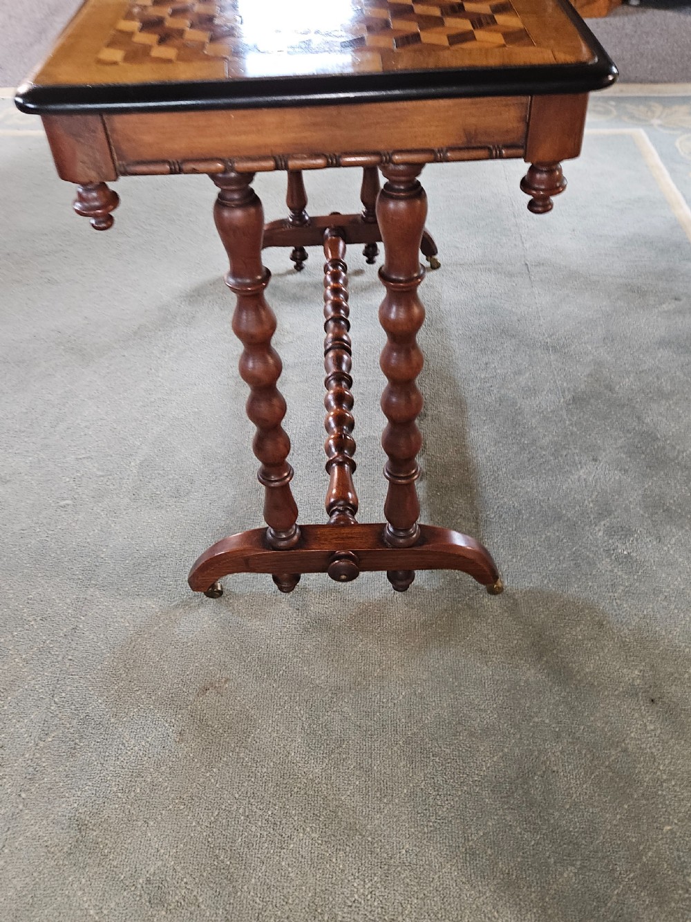 A rectangular wooden side table with a geometric tumbling block parquetry top and barley twist turned legs. View XI