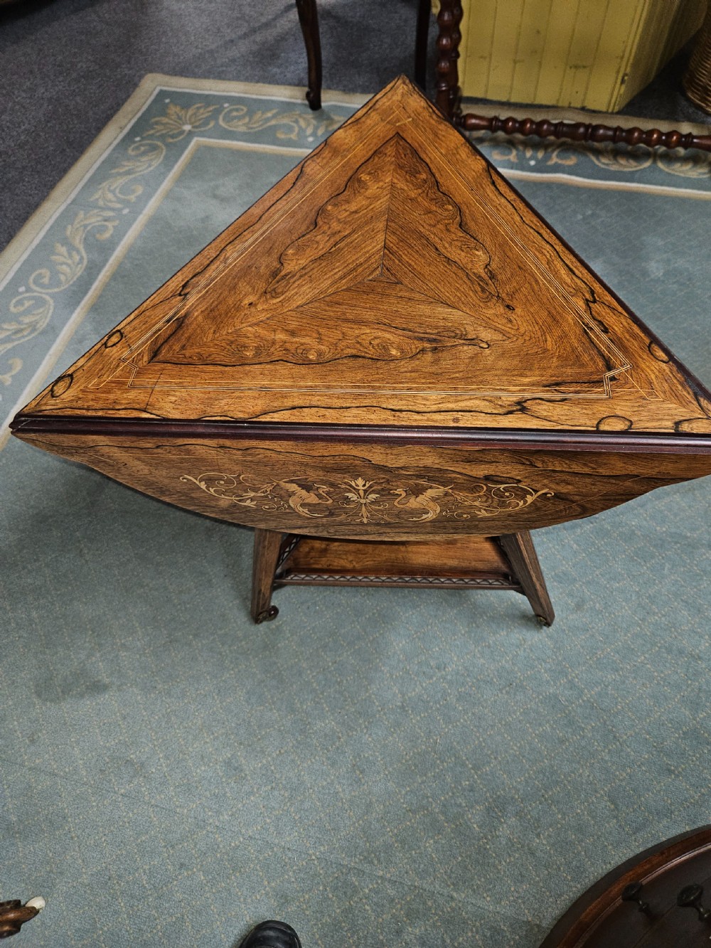 An inlaid rosewood drop-leaf table with extended circular scalloped leaves showing intricate floral marquetry and central geometric grain patterns. View II