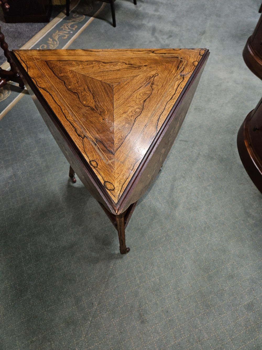 An inlaid rosewood drop-leaf table with extended circular scalloped leaves showing intricate floral marquetry and central geometric grain patterns. View IV