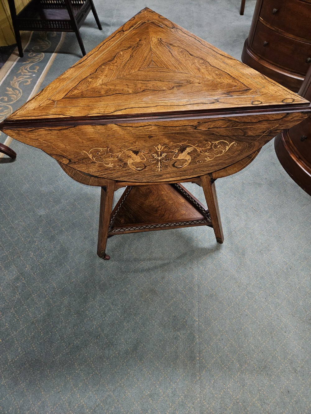 An inlaid rosewood drop-leaf table with extended circular scalloped leaves showing intricate floral marquetry and central geometric grain patterns. View V