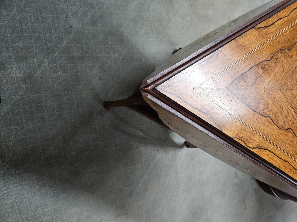 An inlaid rosewood drop-leaf table with extended circular scalloped leaves showing intricate floral marquetry and central geometric grain patterns. View VI