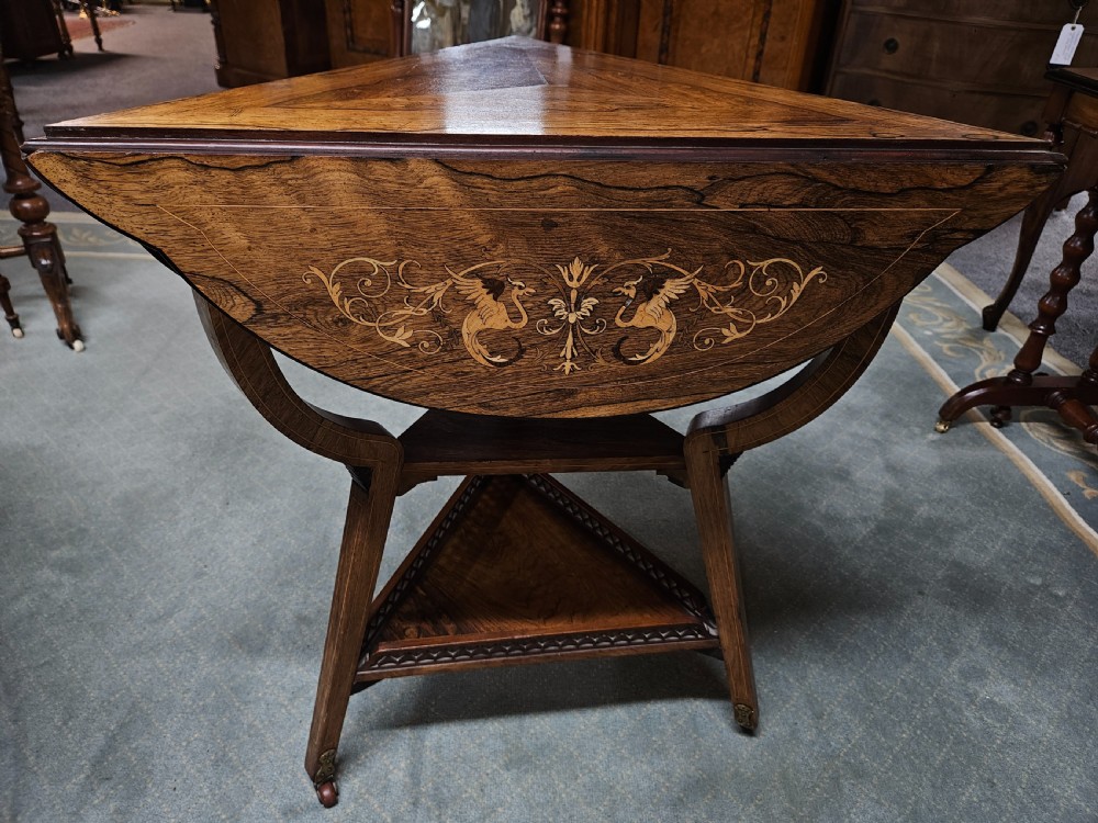 An inlaid rosewood drop-leaf table with extended circular scalloped leaves showing intricate floral marquetry and central geometric grain patterns. View VII