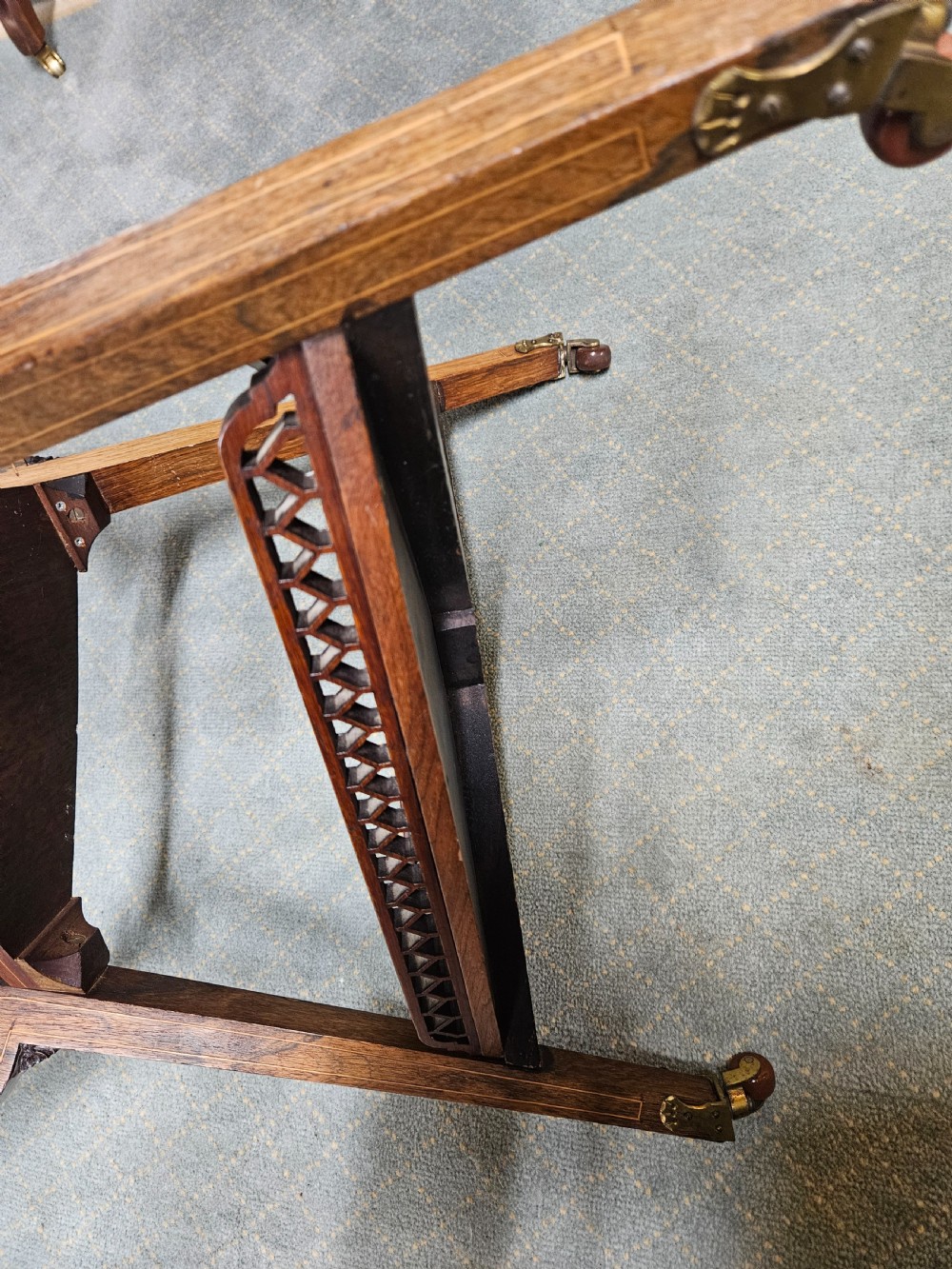 An inlaid rosewood drop-leaf table with extended circular scalloped leaves showing intricate floral marquetry and central geometric grain patterns. View XII