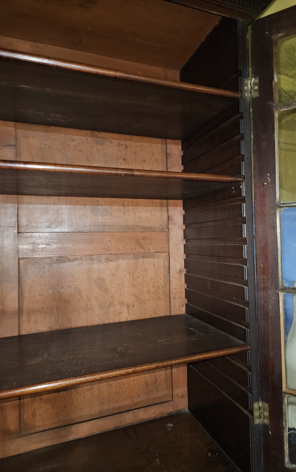A Georgian mahogany secretary bookcase featuring upper astragal glazed double doors above a chest with six graduated drawers and turned knobs. View XII