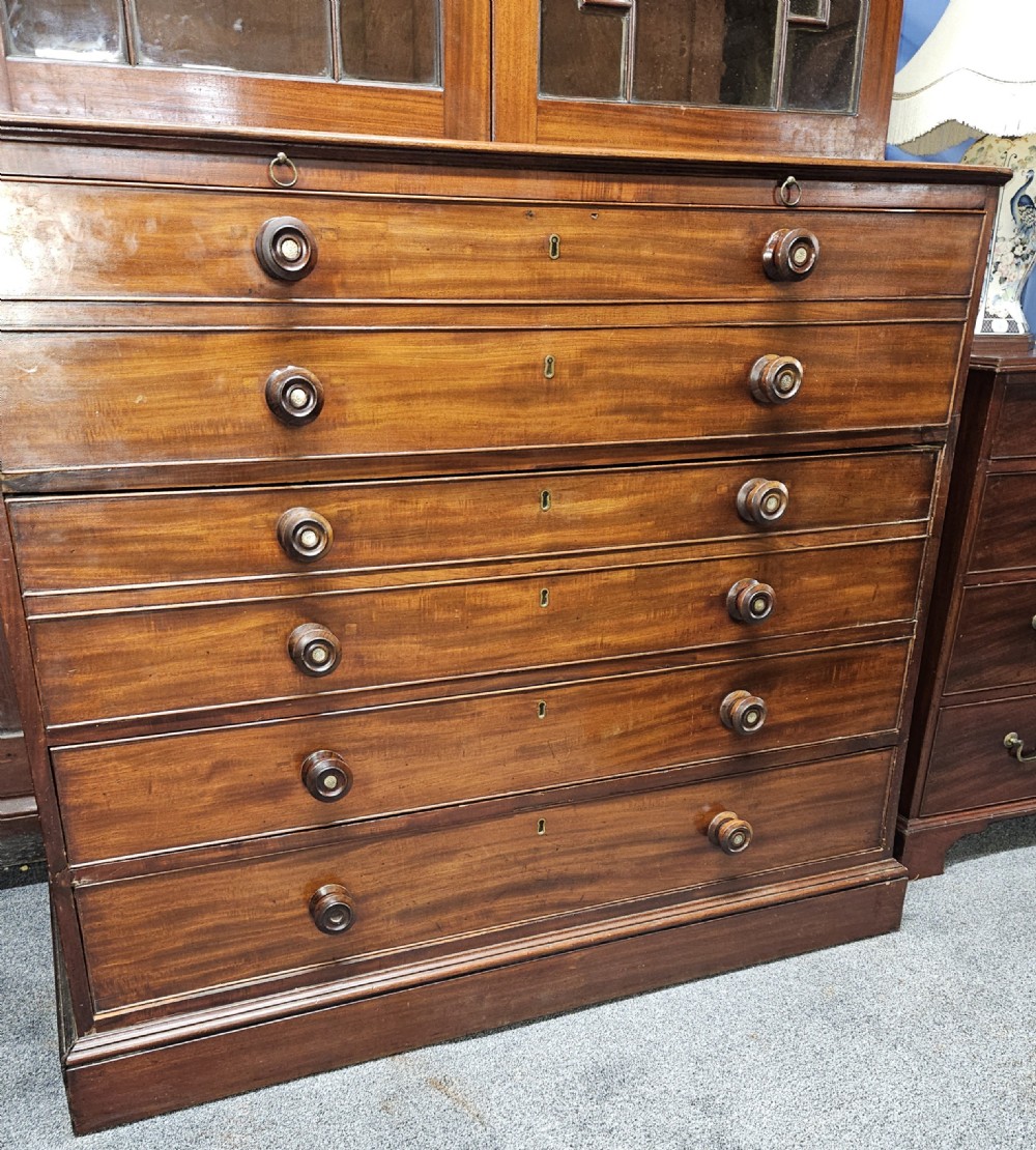 A Georgian mahogany secretary bookcase featuring upper astragal glazed double doors above a chest with six graduated drawers and turned knobs. View XIII
