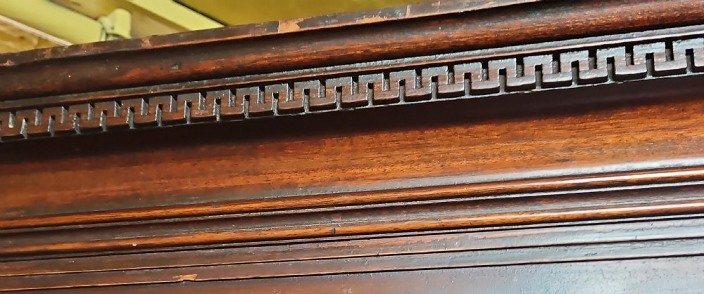 A tall two-tier Georgian mahogany corner cabinet with open upper panelled doors revealing arched interior shelving, set above a two-door base cabinet. View VII