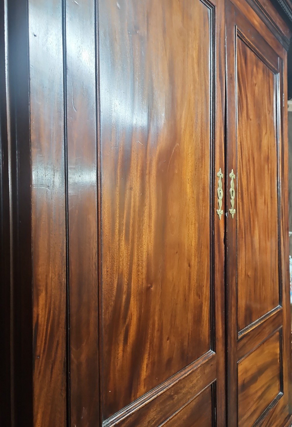 A tall two-tier Georgian mahogany corner cabinet with open upper panelled doors revealing arched interior shelving, set above a two-door base cabinet. View XX