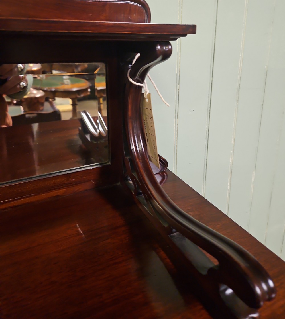 An Art Nouveau dark mahogany music cabinet featuring detailed wood marquetry, a pierced metal cartouche panel, and an upper mirrored gallery shelf. View IX