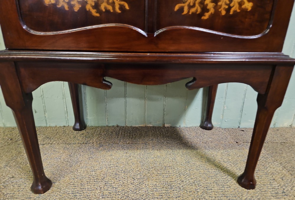 An Art Nouveau dark mahogany music cabinet featuring detailed wood marquetry, a pierced metal cartouche panel, and an upper mirrored gallery shelf. View XVII