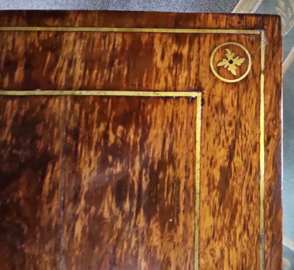 A Regency rosewood games table featuring brass inlay embellishments, a central pedestal, and splayed quadripartite legs with brass caps. View XII
