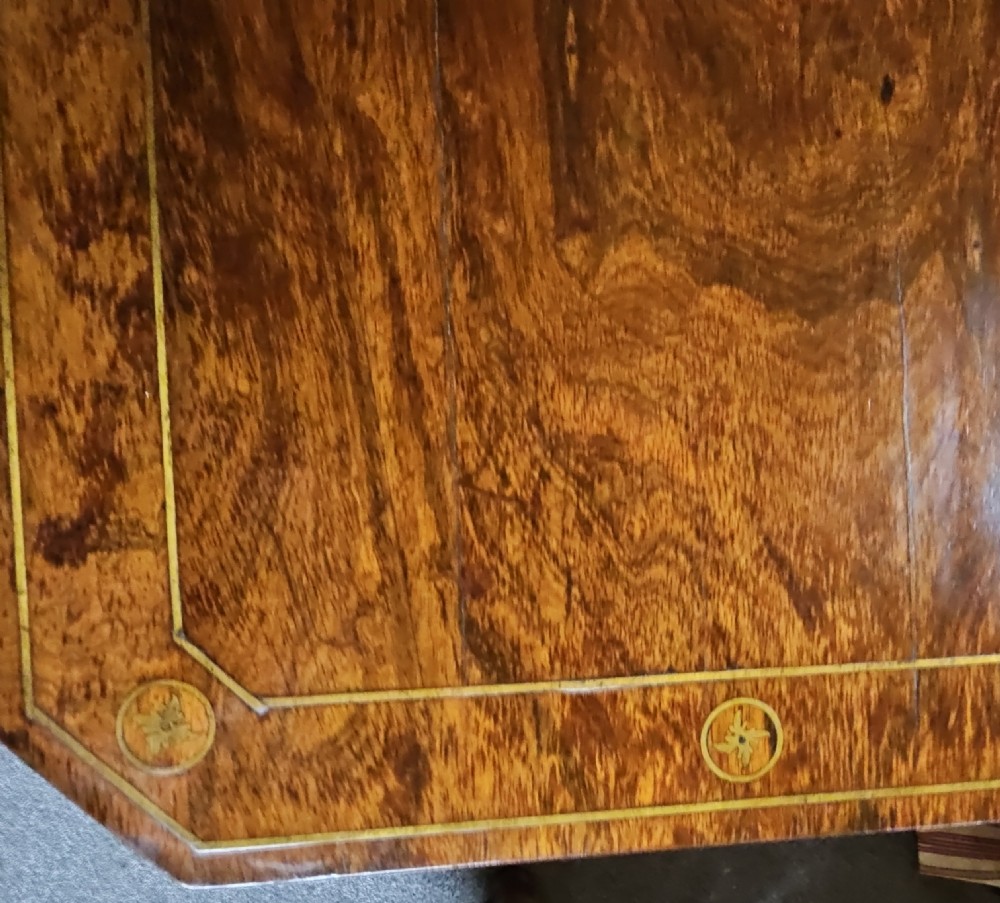 A Regency rosewood games table featuring brass inlay embellishments, a central pedestal, and splayed quadripartite legs with brass caps. View XIII