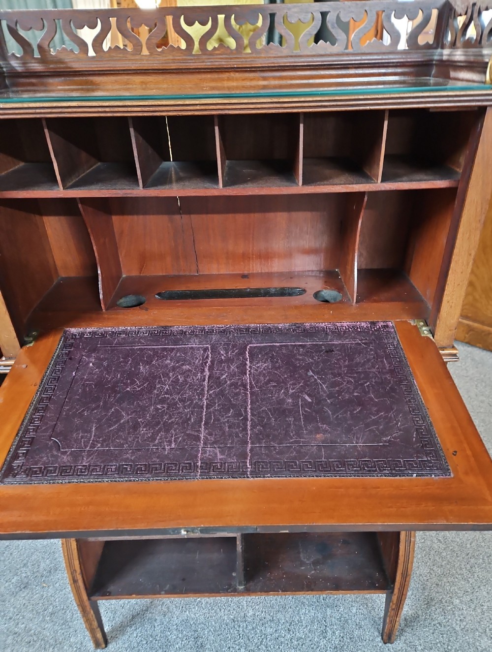 A late Victorian warm brown wood writing bureau featuring a pierced top gallery, twin upper panels, a middle drawer with a brass pull, and a slatted tambour front lower section. View III