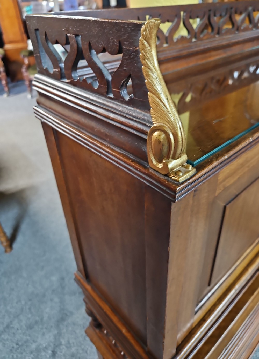 A late Victorian warm brown wood writing bureau featuring a pierced top gallery, twin upper panels, a middle drawer with a brass pull, and a slatted tambour front lower section. View IV
