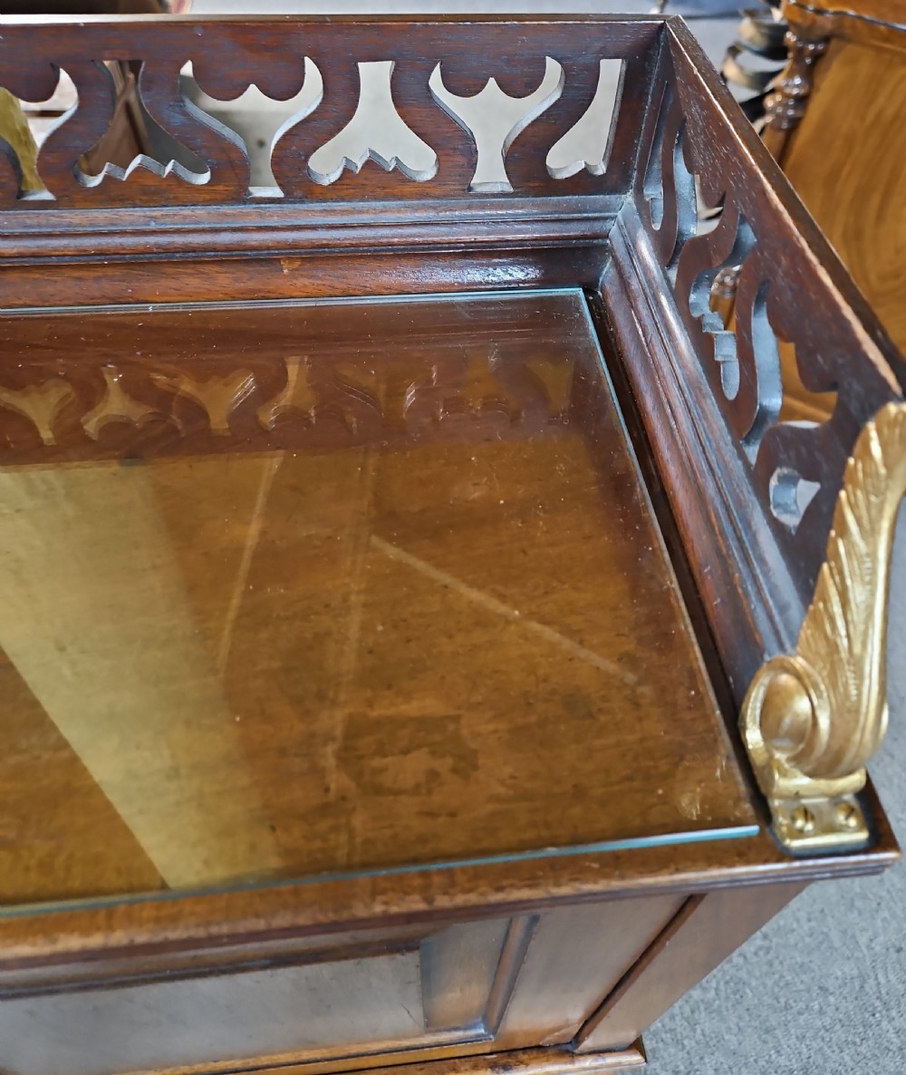 A late Victorian warm brown wood writing bureau featuring a pierced top gallery, twin upper panels, a middle drawer with a brass pull, and a slatted tambour front lower section. View V