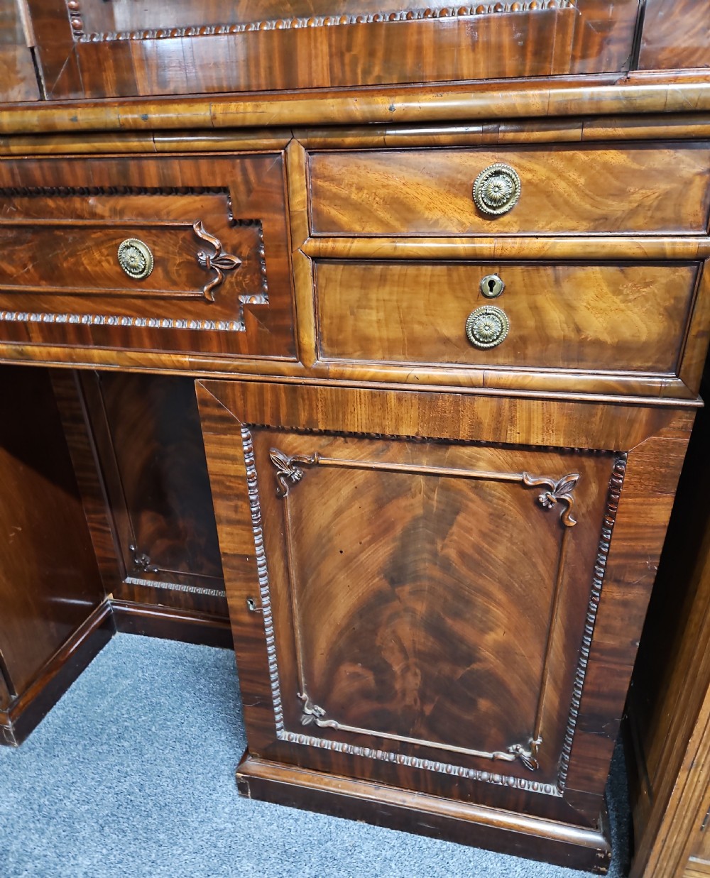 A William IV mahogany secretary bookcase featuring a two-door upper section, a central secretary drawer, and a lower kneehole flanked by cupboards with spirally turned columns. View III